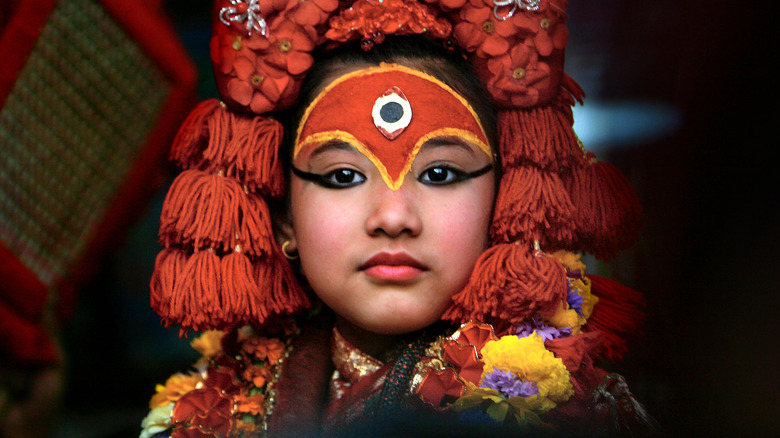 Kumari Devi, or Royal Living Goddess, Preeti Shakya, 9, watches the White Machindranath Chariot festival from a window March 28, 2007 in Kathmandu, Nepa