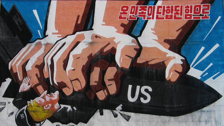 North Korean propaganda poster of hands crushing the US
