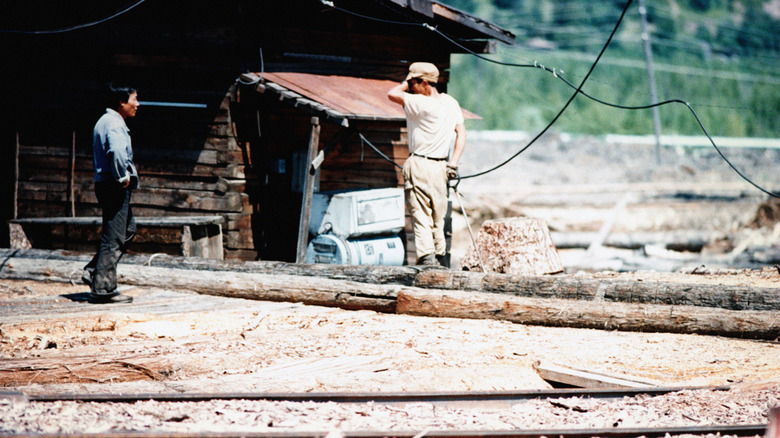 Two men interacting in a North Korean labor camp
