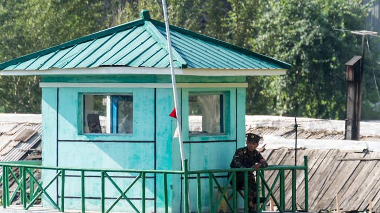 Hyesan, Ryanggang province, North Korean soldier guarding the border at the Yalu river