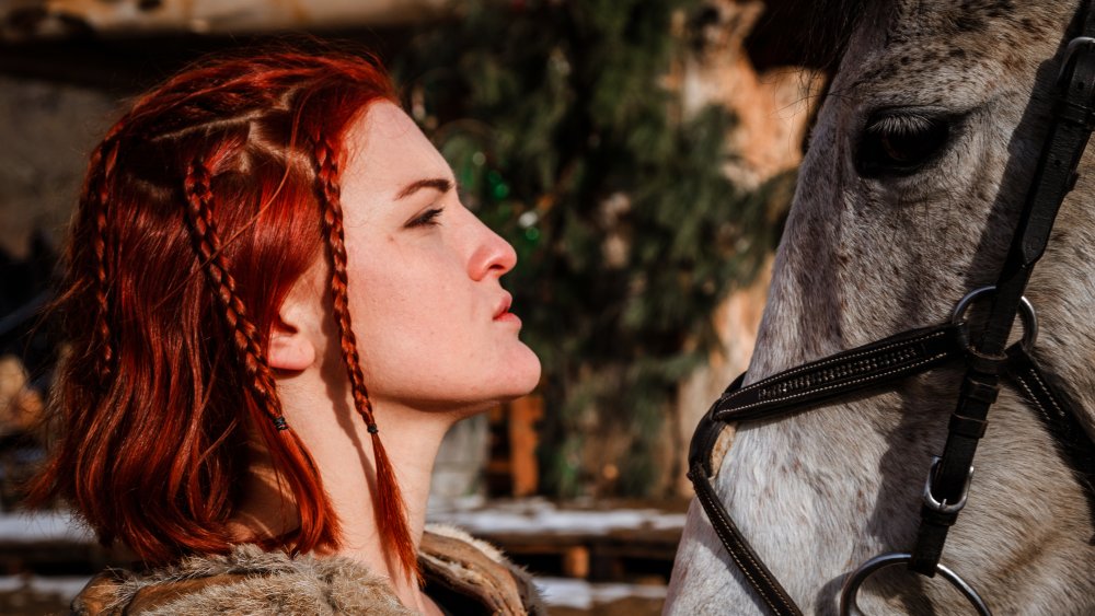 A Celtic woman and her horse preparing for combat