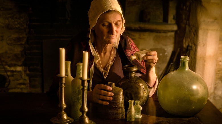 medieval woman mixing potions