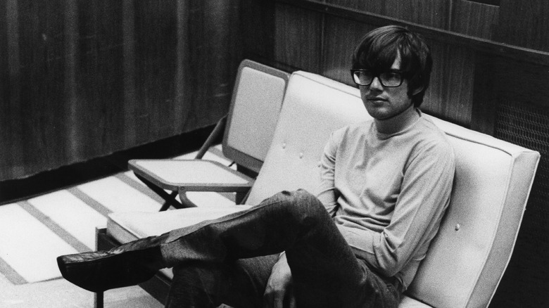 Young Jimmy Webb seated in glasses