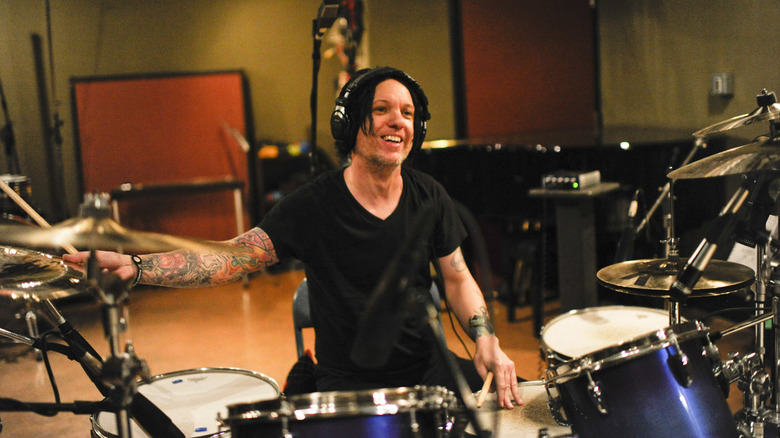 Chris Vrenna playing drums in studio while smiling