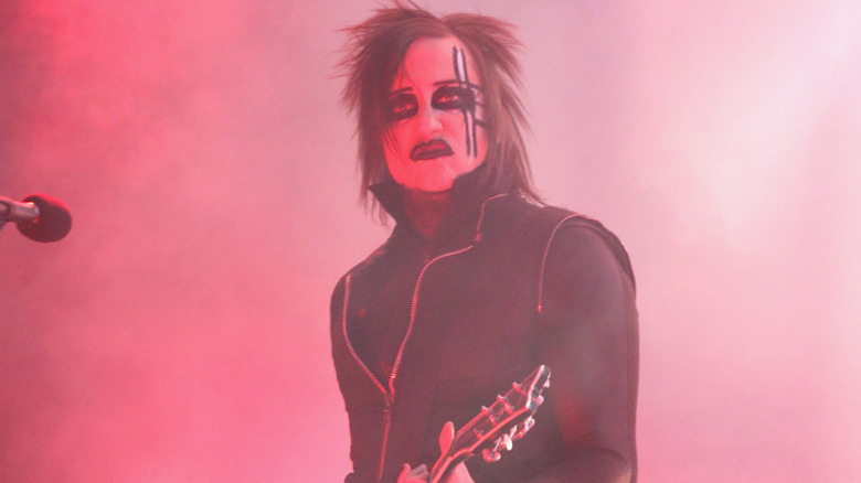 Paul Wiley playing guitar for Marilyn Manson on stage in face paint