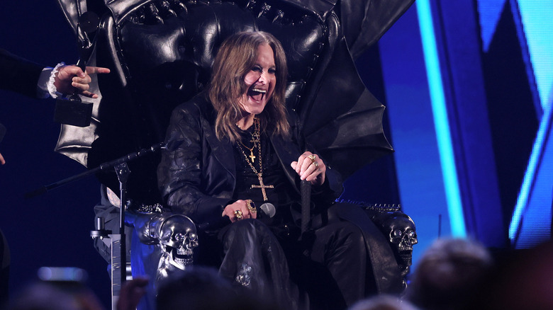 Ozzy Osbourne on throne on stage laughing