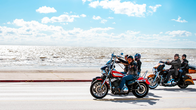 Motorcyclists by the ocean