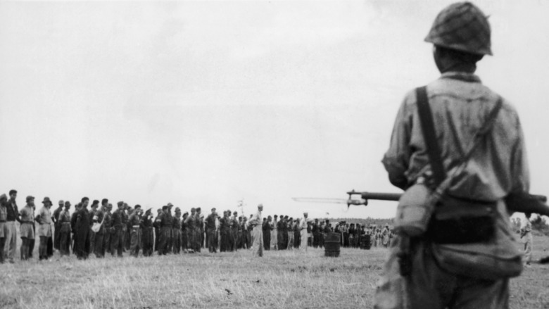 Men lined up in a field