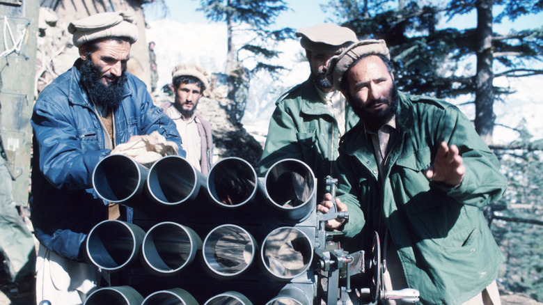 Mujahideen outside with weapons