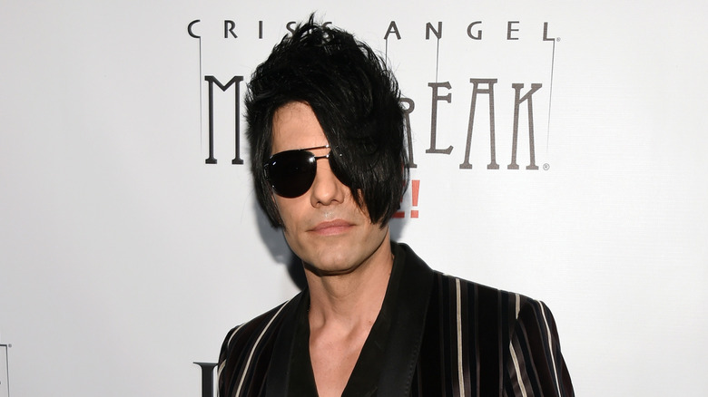 Criss Angel at Mindfreak Live event hair in face with sunglasses