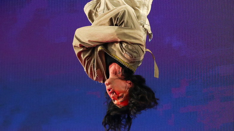 Criss Angel upside down in straightjacket onstage