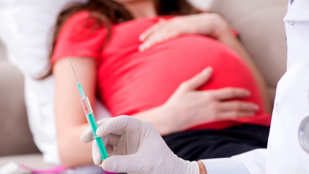 A generic image of a pregnant woman at a doctor's clinic