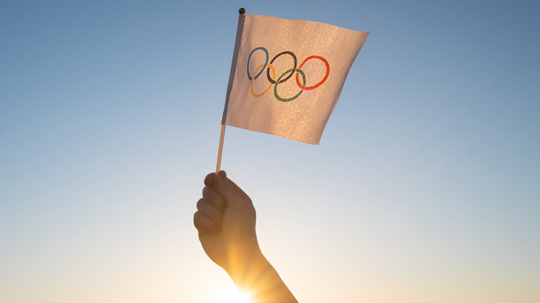 holding the Olympic flag