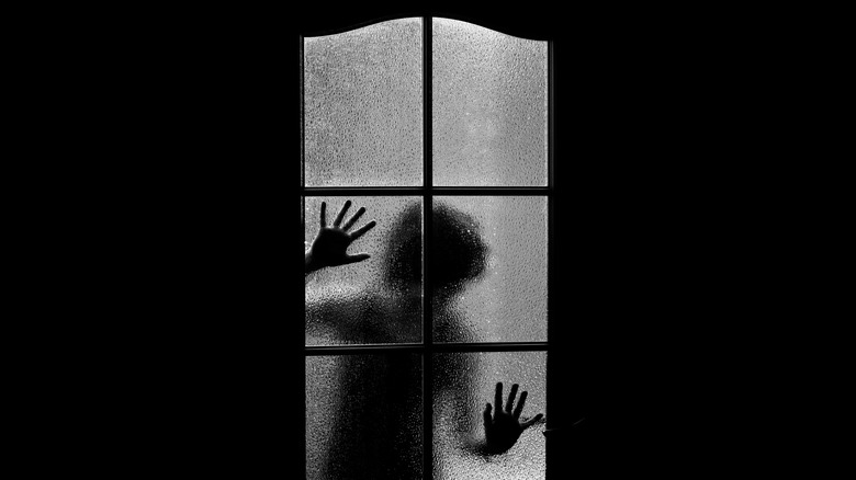Silhouette behind glass