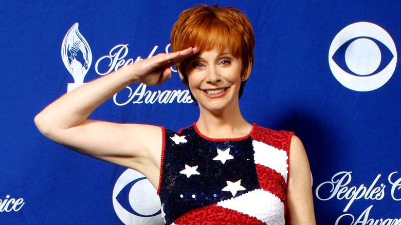 ewba mcentire wearing an american flag outfit and saluting