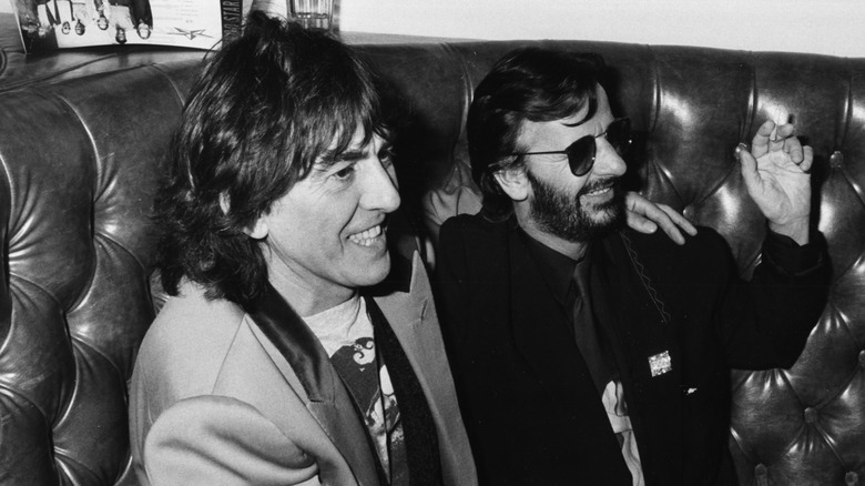 George Harrison having a drink with Ringo Starr in 1985