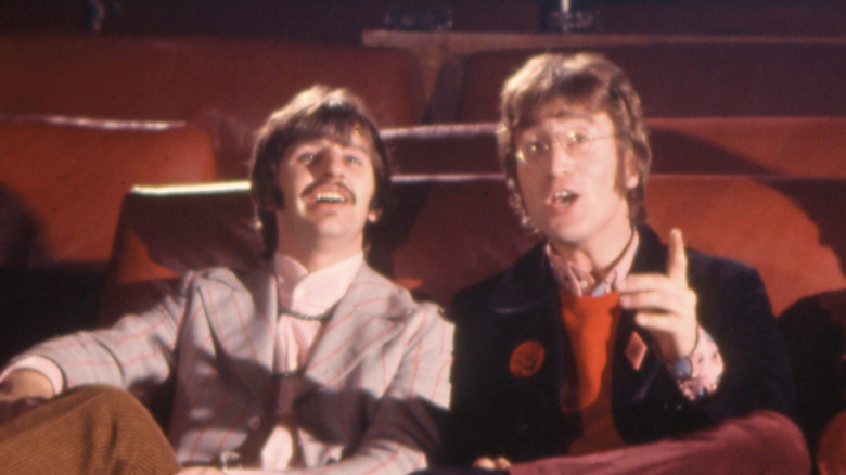Ringo Starr sitting with John Lennon in a movie theater