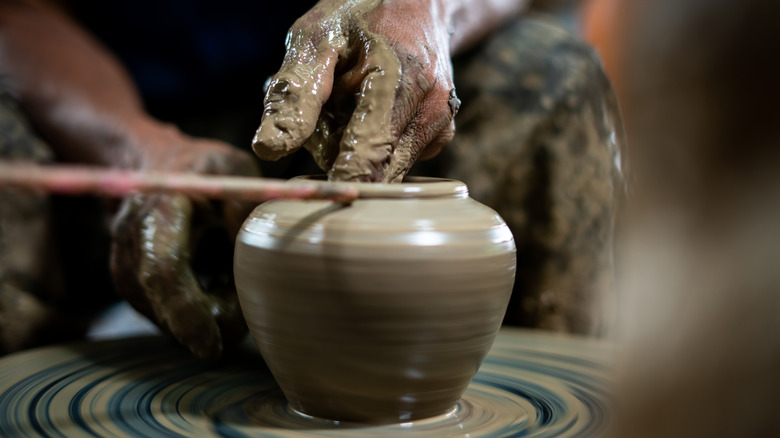 Person making a clay pot