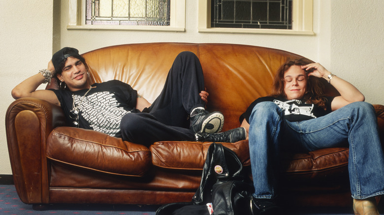Slash and Eric Dover laying on couch