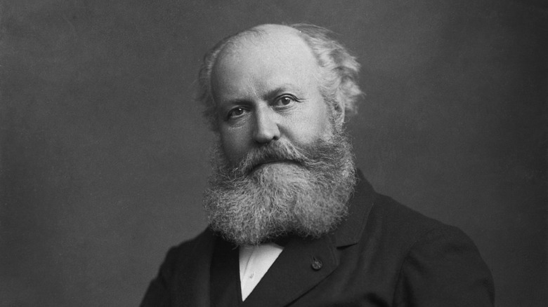 Charles Gounod sat with beard in dark suit
