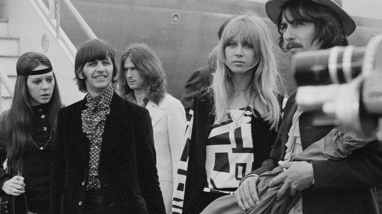 Ringo Starr George Harrison and their wives on an airfield