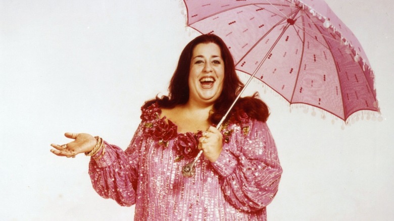Cass Elliot in pink with umbrella