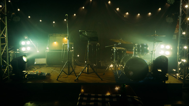 Dimly lit photo of bar stage with instruments
