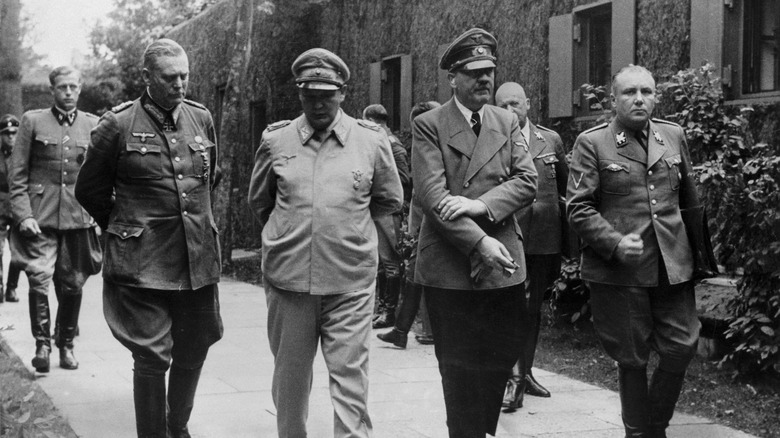 Adolf Hitler walking outside with his generals