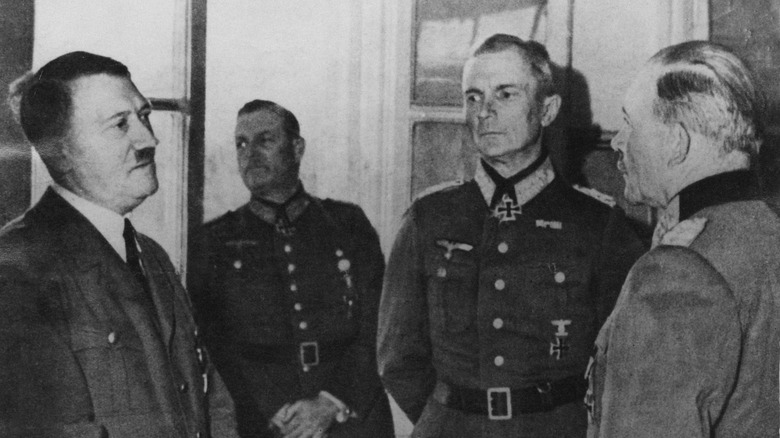 Adolf Hitler speaking with some of his generals