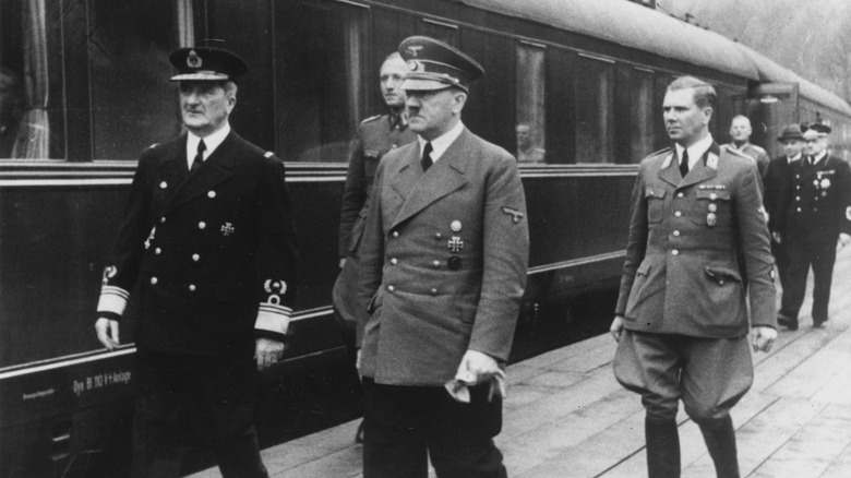 Adolf Hilter meeting a dignitary at a train station