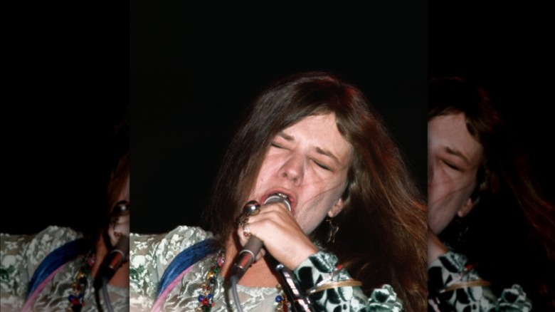Janis Joplin singing emotionally into a microphone