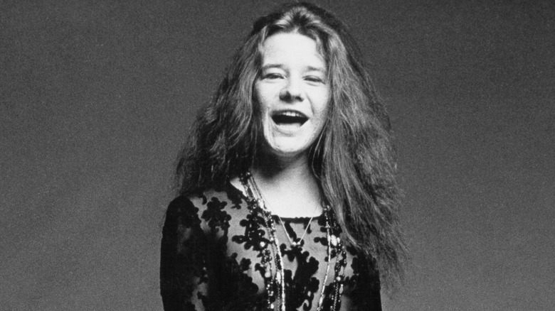 Janis Joplin with her mouth open in a posed photo