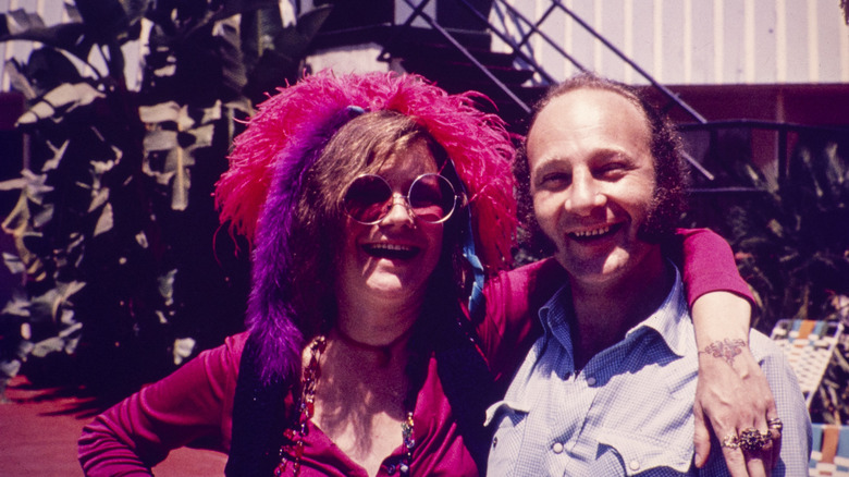 Janis Joplin with her arm around a record producer