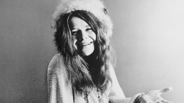Janis Joplin smiling in a fur hat