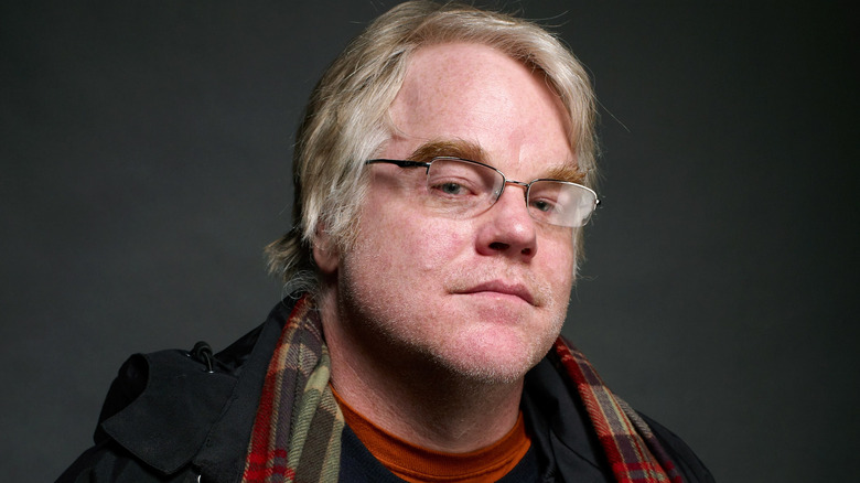 Philip Seymour Hoffman wearing scarf and looking askance into camera
