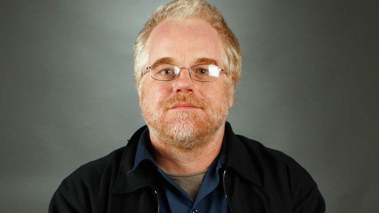 Philip Seymour Hoffman head tilted back eyes looking into camera