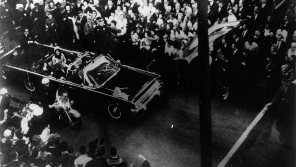 US statesman John F Kennedy, 35th president of the US, and his wife Jackie Kennedy travelling in the presidential motorcade at Dallas, before his assassination.