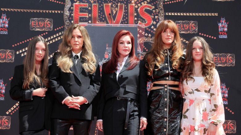 Presley family Elvis film event smart black posing