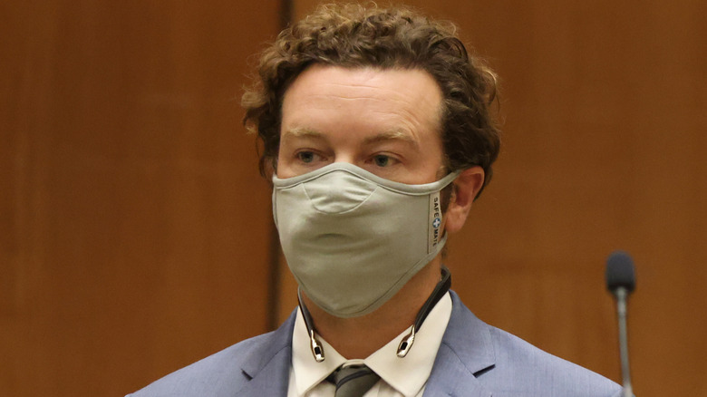 Danny Masterson in court beige mask listening