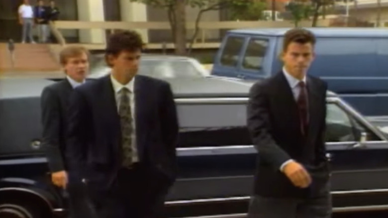 Menendez brothers in suits leaving vehicle