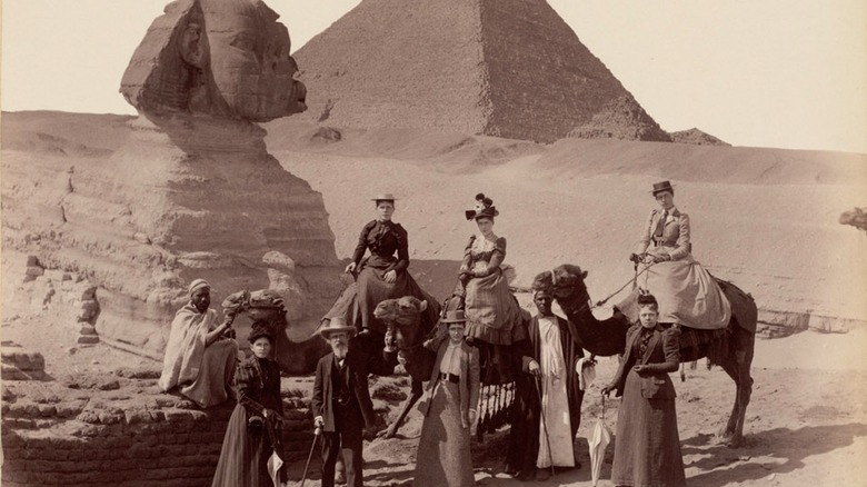 Group of tourist in front of the Sphinx and pyramid 1800s