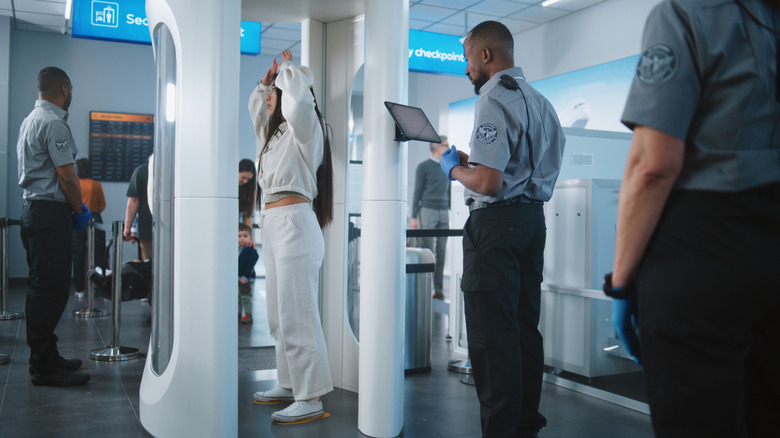 Passenger passing through TSA scan