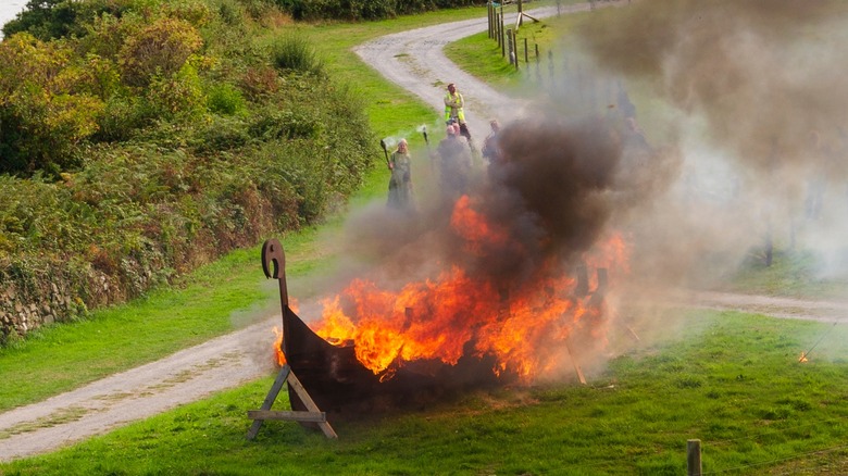 2022 recreation of Viking ship cremation in field