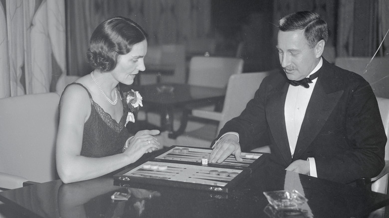 A couple plays backgammon on opening night
