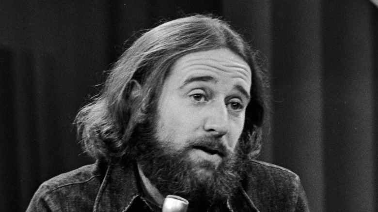George Carlin beard head tilted