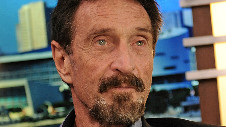 John McAfee poses for a photograph