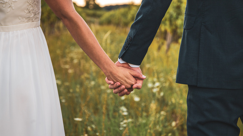 Newlyweds holding hands