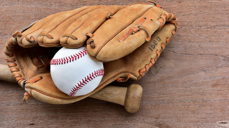 a baseball, glove and bat