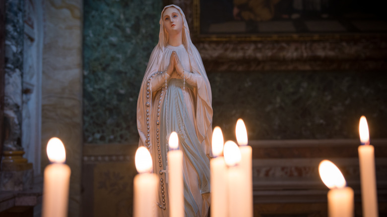 Mary Magdalene statue with candles