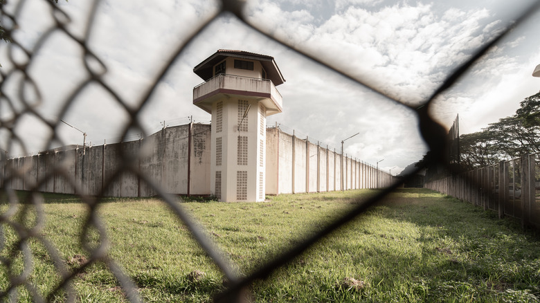 Prison viewed through chainlink fence